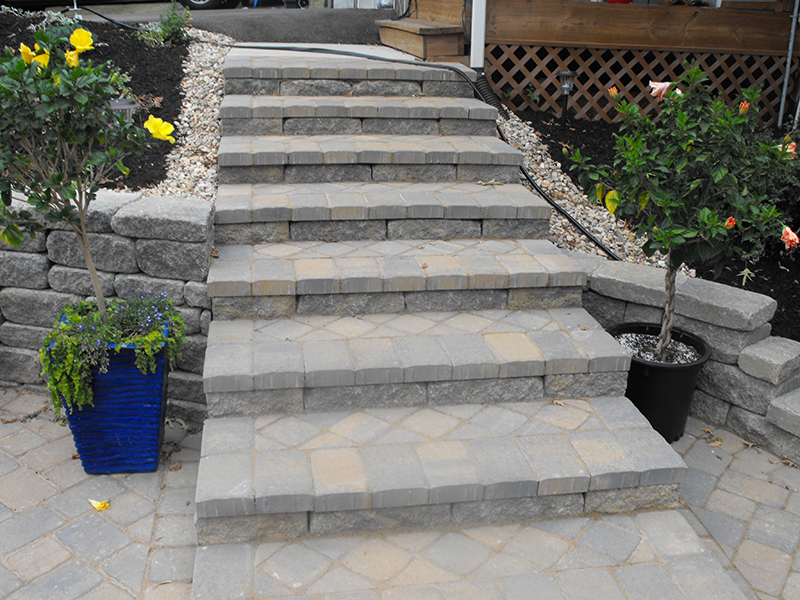 Natural stone patio with retaining wall and outdoor seating area